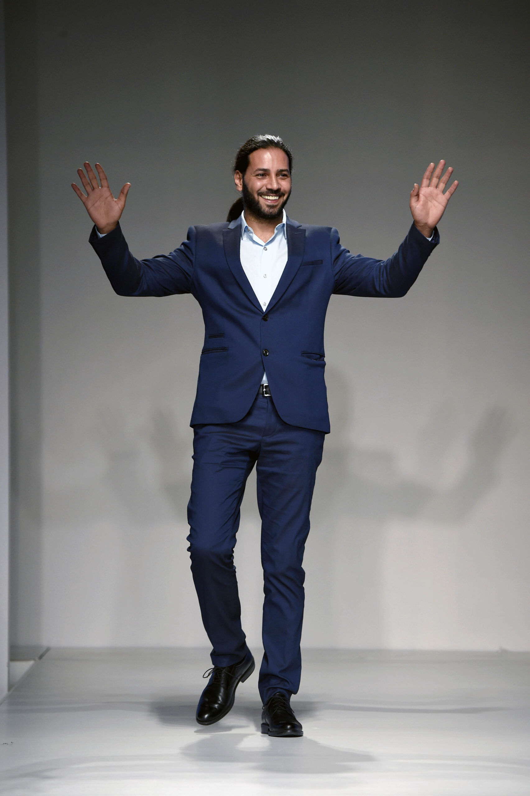 International hairstylist Fadi Nasr on the runway at Arab Fashion Week, celebrating the success of his "Tree of Life" hairstyle presentation.