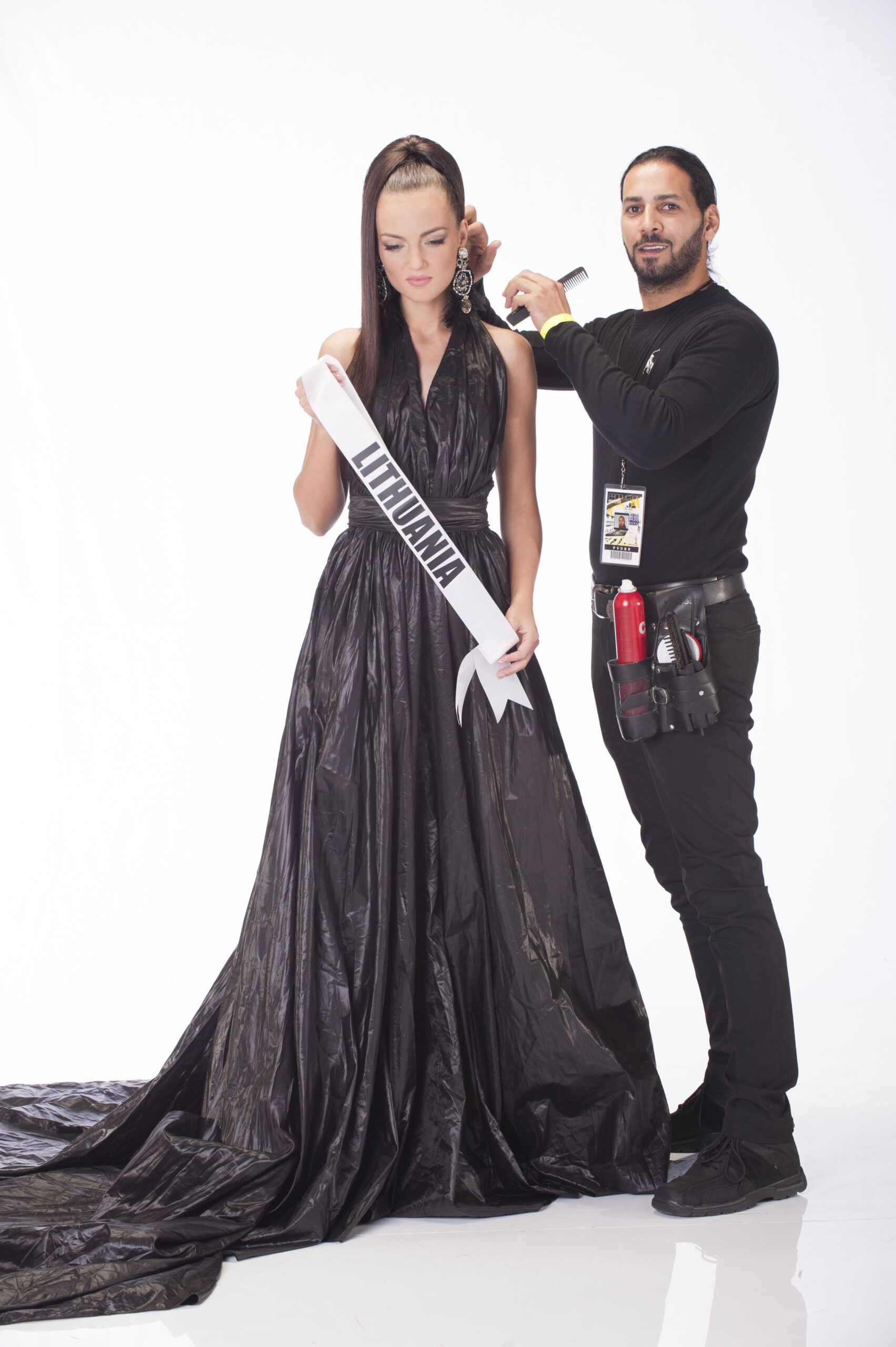 International hairstylist Fadi Nasr applying the final hair touches to a Miss Universe contestant from Lithuania, ensuring a flawless look for the competition.